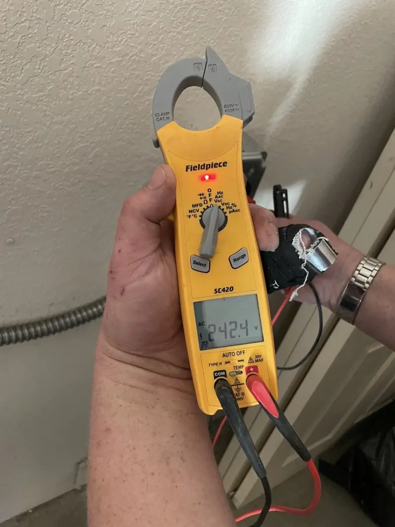 Voltage testing with clamp meter during Ceiling Fan Installation in Moab